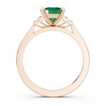 Bezel set three stone emerald engagement ring in rose gold, side profile