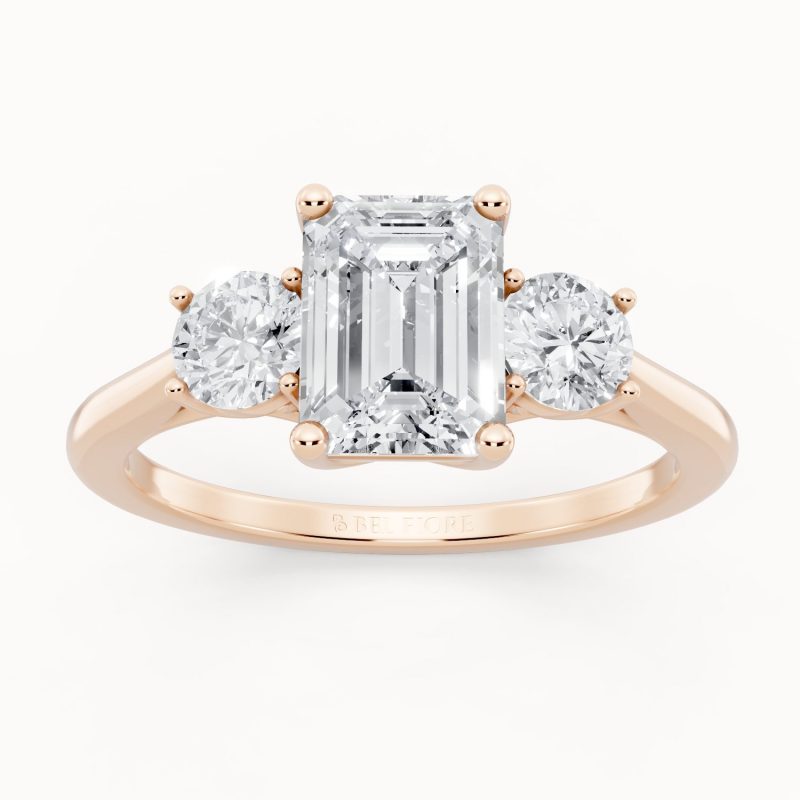 Emerald & Round Three Stone Engagement Ring in rose gold, front view