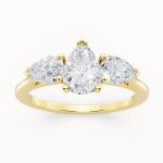 Pear Cut Three Stone Engagement Ring in yellow gold, front view